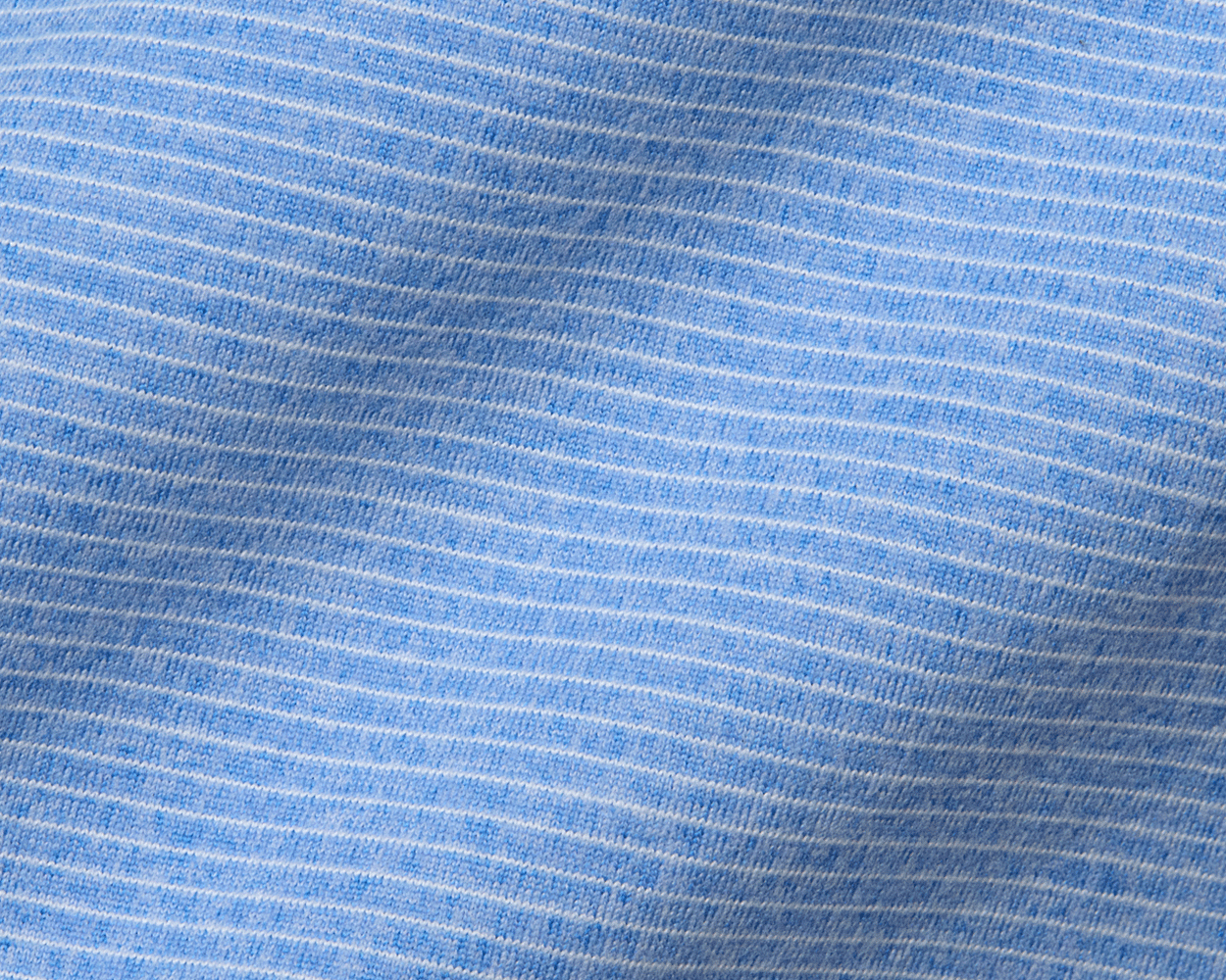 The Royce Quarter-Zip: Heathered Horizon Blue features a close-up of fine-knit texture with white stripes, highlighting its soft, stretchy, moisture-wicking fabric.