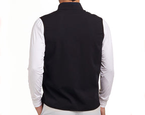 Back view of The Ventura Vest: Black, showcasing its sleeveless design over a white top, highlighting ultralight, breathable fabric with hidden zippered pockets.