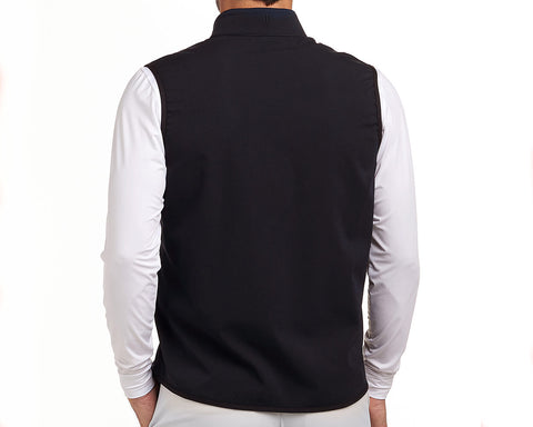 Back view of The Ventura Vest: Black, showcasing its sleeveless design over a white top, highlighting ultralight, breathable fabric with hidden zippered pockets.