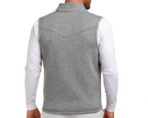 The Ashby Vest: Heathered Gray, shown from the back, features a sleeveless design over a white shirt, with tonal accents and a brushed interior for comfort.