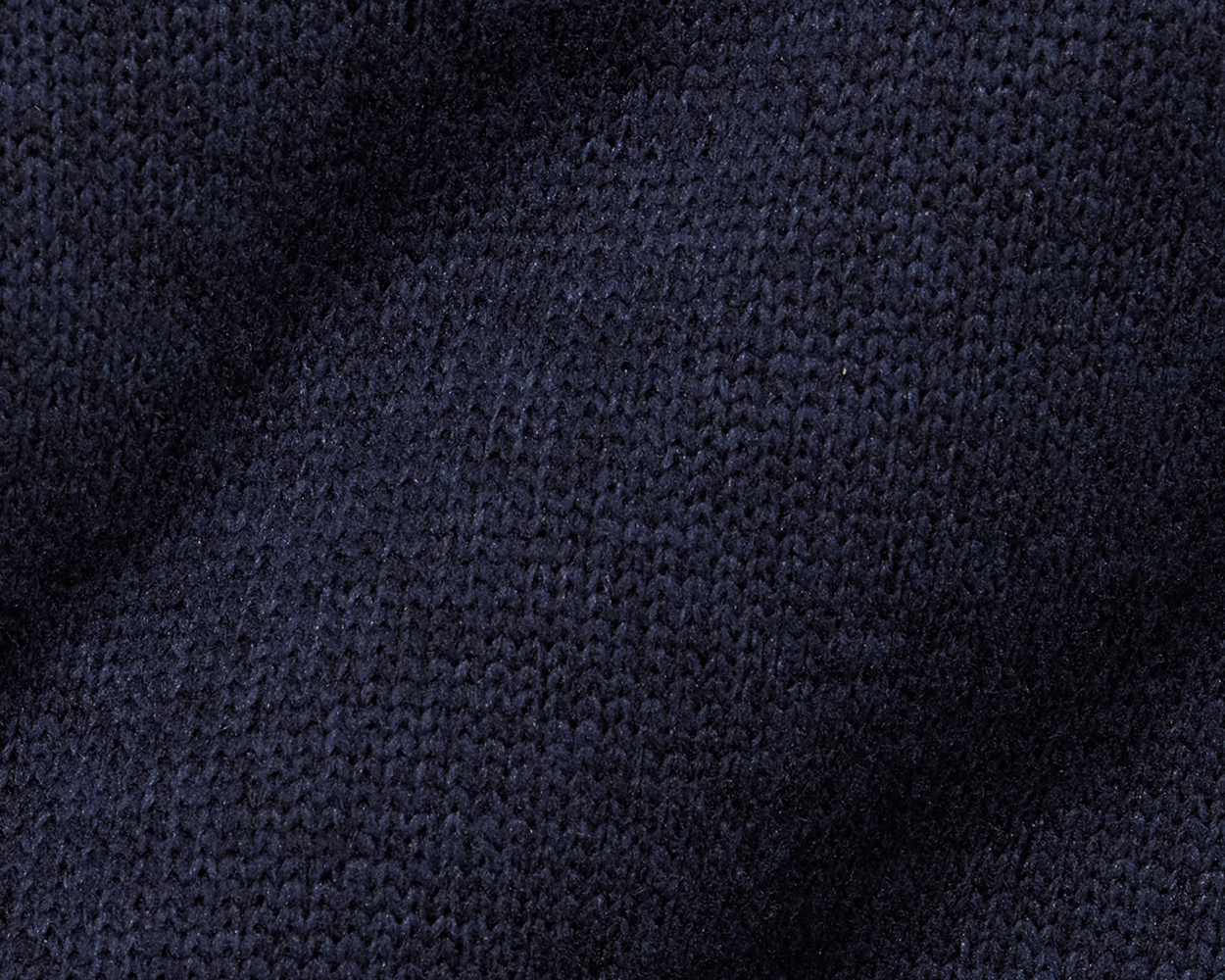 The Ashby Vest: Heathered Dark Navy, showcasing a close-up of its knitted texture, features stylish tonal accents and low-profile pockets for everyday comfort and versatility.