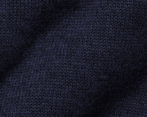 The Ashby Vest: Heathered Dark Navy, showcasing a close-up of its knitted texture, features stylish tonal accents and low-profile pockets for everyday comfort and versatility.