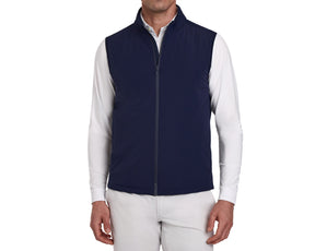 The Swenson Vest: Navy, shown on a male model, offers a sleek, sleeveless design with zip-front, ideal for warmth and flexibility on the golf course.
