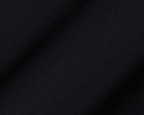 Close-up of The Boyd Vest: Black fabric, showcasing its fine woven texture and soft folds, highlighting the vest's windproof and water-resistant qualities.