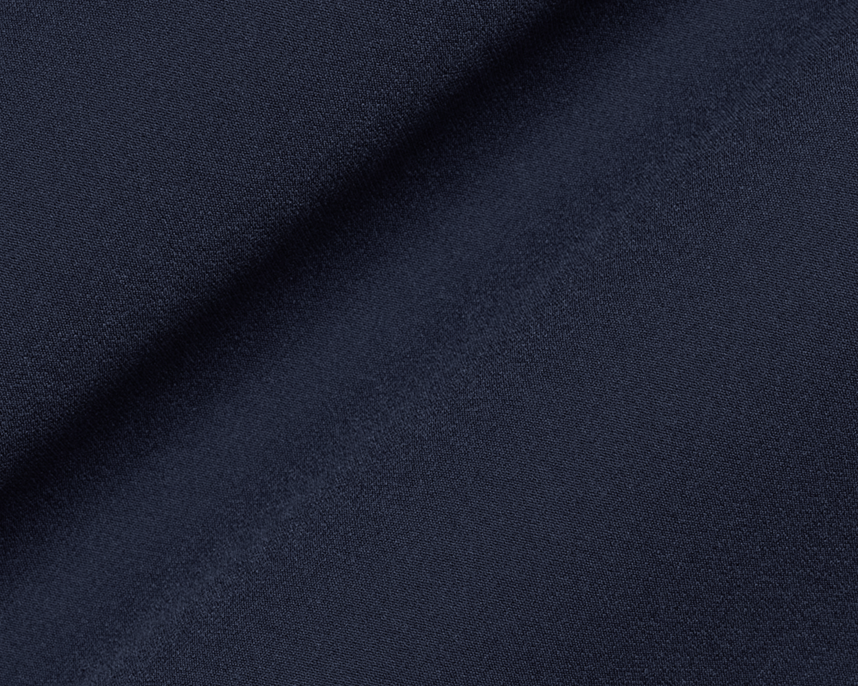 The Boyd Vest: Navy, shown in close-up, highlighting its fine weave and diagonal drape, epitomizes windproof, water-resistant performance with lightweight, four-way stretch fabric.
