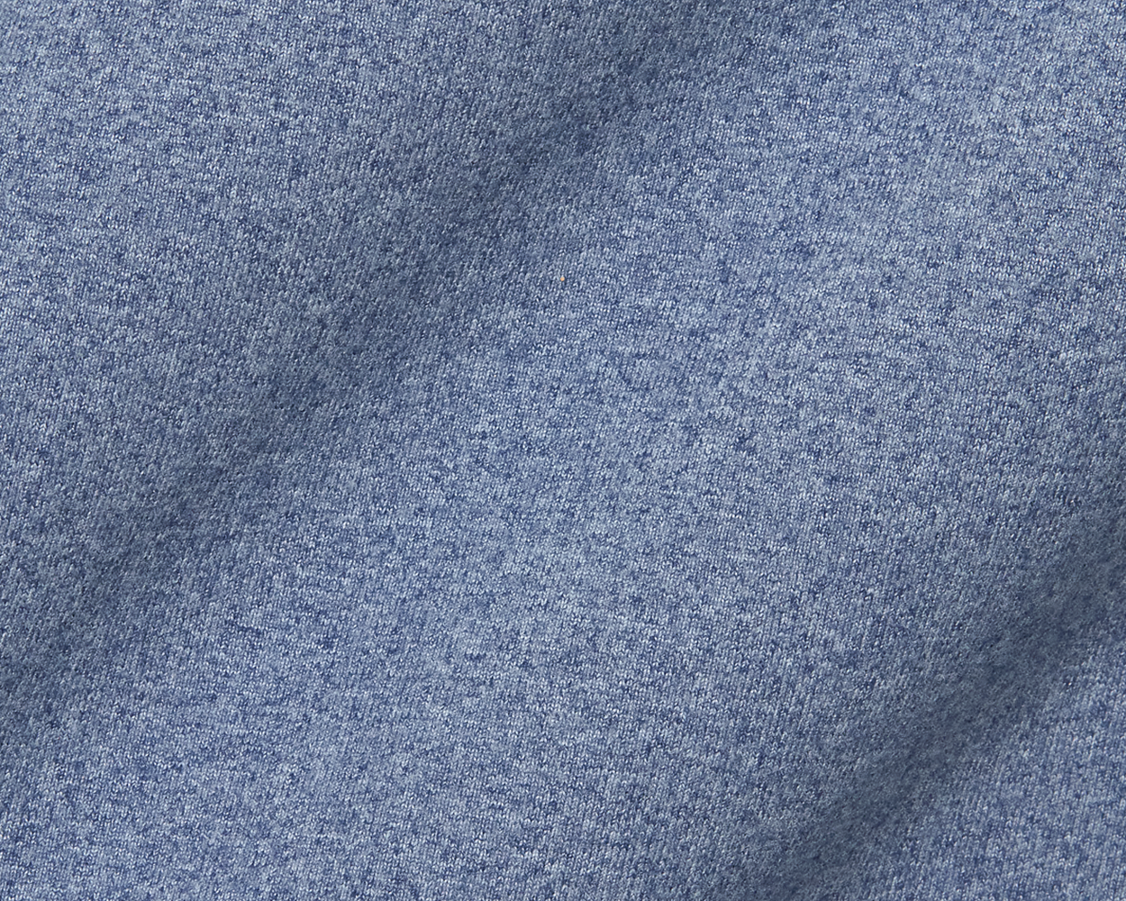 The Westland Quarter-Zip: Heathered Andover, showcasing detailed blue knit fabric with tiny loops, highlighting its soft, moisture-wicking peached synthetic blend.