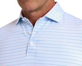 Man wearing The Stanley Shirt in light-blue stripes, featuring a spread collar and micro perforations for breathability and sun protection.