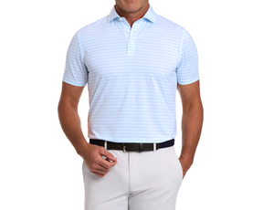 Man wearing The Stanley Shirt in light-blue with fine stripes, tucked into light trousers with a dark belt, showcasing breathable, moisture-wicking fabric.