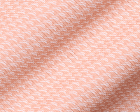 The Eaton Shirt: Nectarine, featuring a soft, peach-hued textile with a subtle wave pattern, designed for comfort, air circulation, moisture wicking, and sun protection.