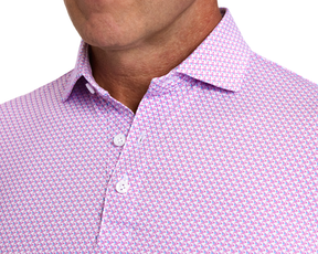 The Justice Shirt: Horizon Blue & Cabernet features a geometric pattern on a light fabric, button-up design, with a structured collar and performance jersey material.