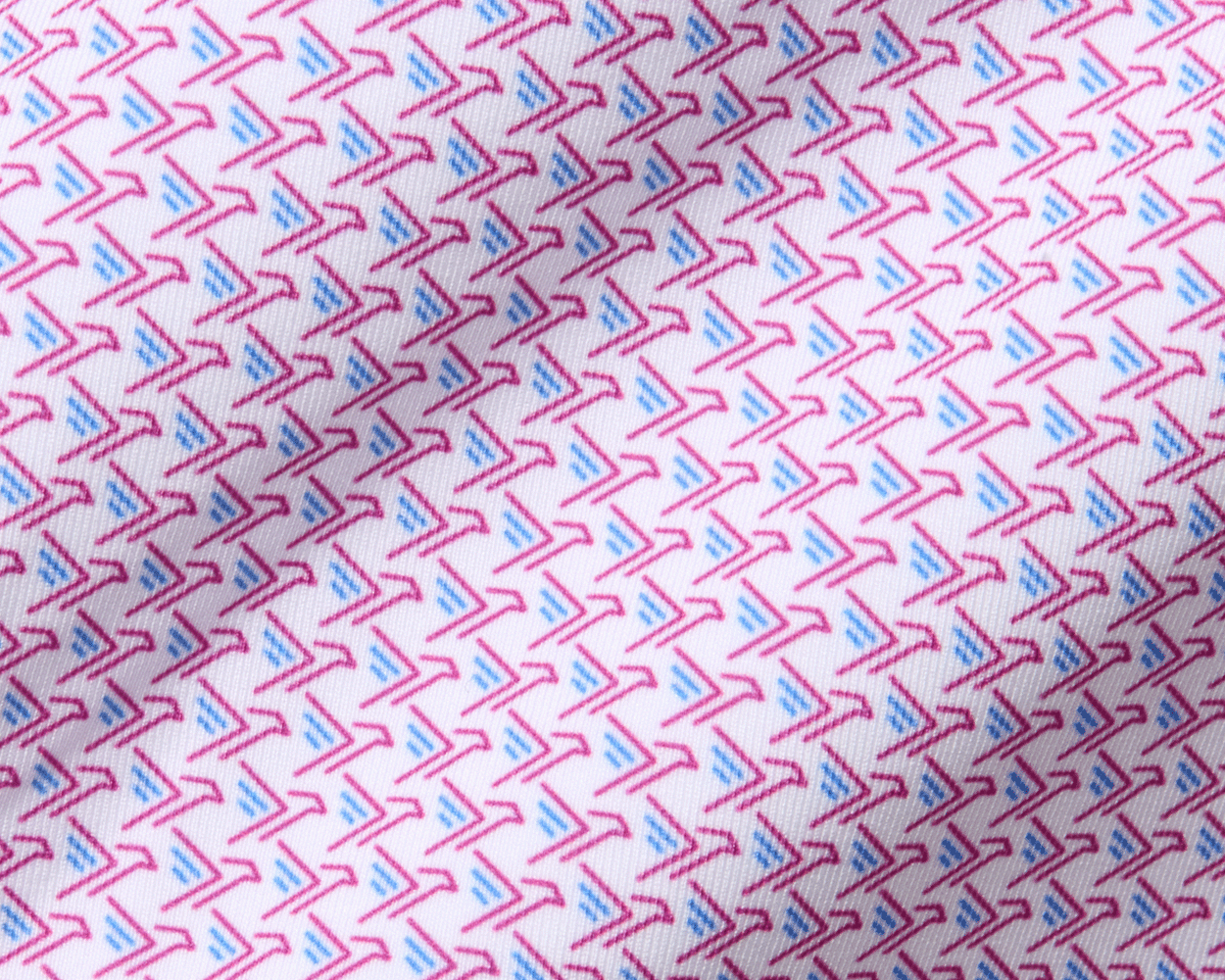 The Justice Boys Shirt: Horizon Blue & Cabernet features a close-up of a geometric pattern with pink boomerangs and blue strokes on soft, performance jersey fabric.