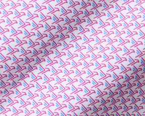 The Justice Boys Shirt: Horizon Blue & Cabernet features a close-up of a geometric pattern with pink boomerangs and blue strokes on soft, performance jersey fabric.