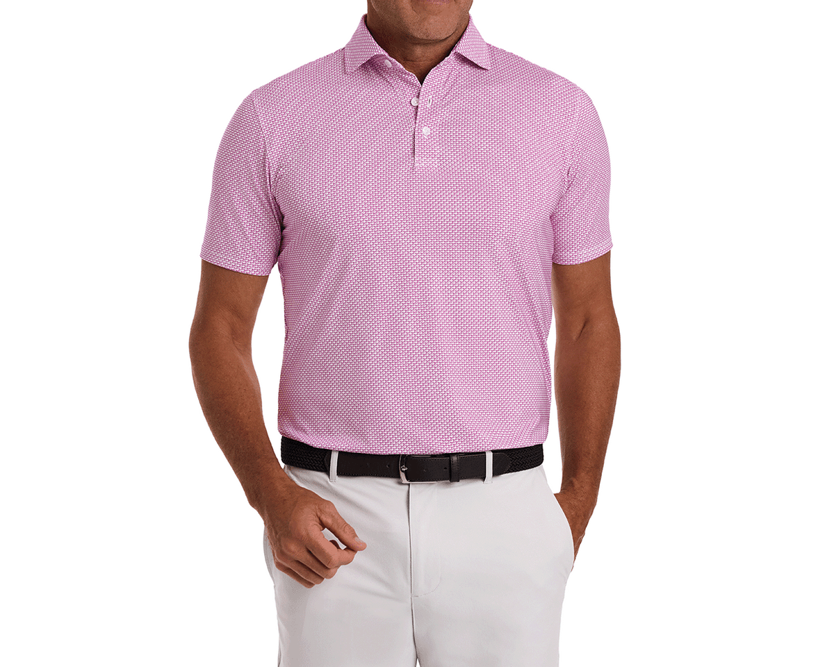 The Hanover Shirt: Cabernet, a short-sleeve polo with a geometric pattern, shown tucked into white trousers, featuring a spread collar and performance fabric.