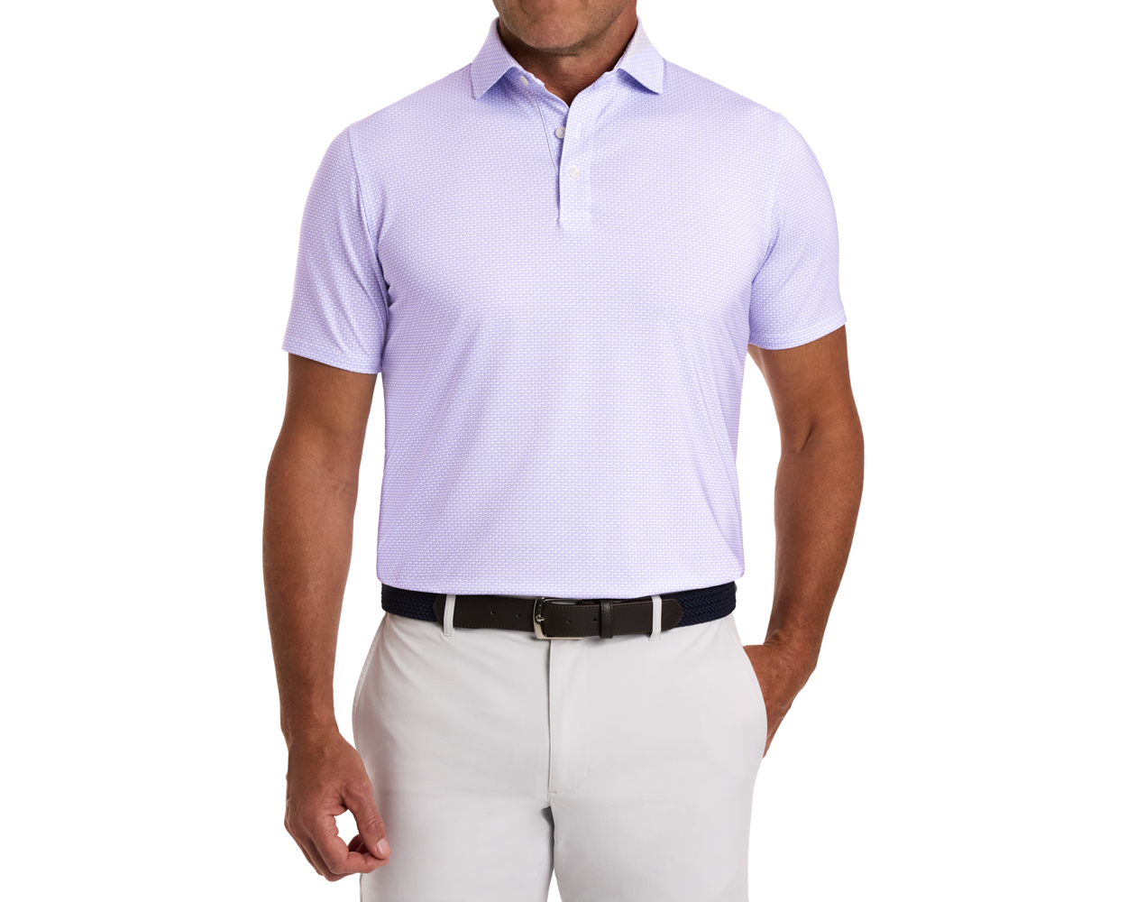 The Hanover Shirt: Tudor showcased in a geometric pattern, short-sleeve polo design, tucked into trousers, highlighting its structured spread collar and comfortable fit.