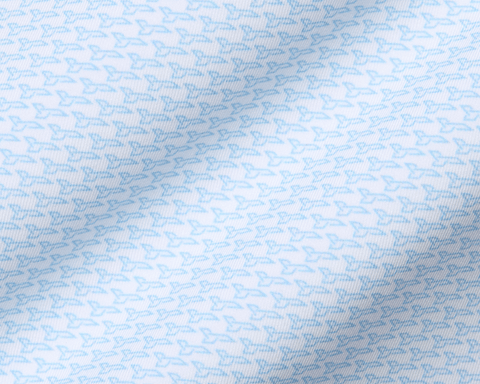 The Hanover Shirt: Vista Blue features a light fabric with a micro-pattern of stylized birds, showcasing gentle folds and intricate textile weave.