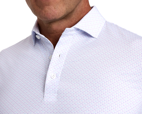 The Cadogan Shirt: Tudor & Vista Blue features a breathable polo with lilac-toned pattern, classic collar, and two-button placket.