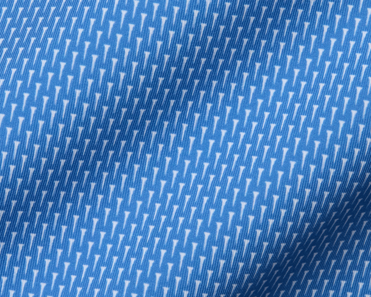 The Hicks Boys Shirt: Horizon Blue features a blue woven fabric with a subtle white arrow motif, perfect for breathable comfort and style.