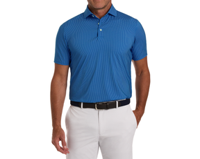 Man wearing The Hicks Shirt: Maidstone Blue, a blue patterned polo with short sleeves, tucked into light pants, showcasing a polished, breathable design suitable for golf.
