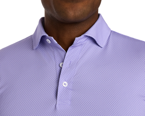 The Hicks Shirt: Tudor features a light purple geometric pattern, short sleeves, and a structured collar, offering breathability and UPF 50+ protection.