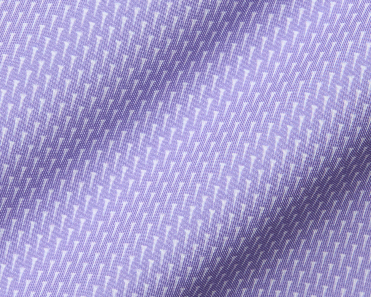 Close-up of The Hicks Shirt: Tudor, highlighting its woven fabric with geometric T-shaped motif, showcasing quality and performance-enhancing features like moisture wicking and UPF 50+ protection.