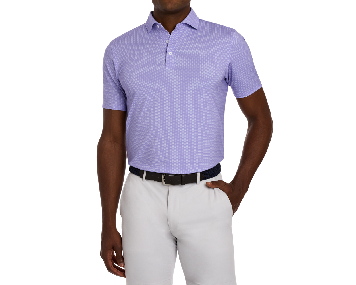 The Hicks Shirt: Tudor features a geometric golf-tee pattern, short sleeves, and a structured collar, paired with light trousers and a black leather belt.