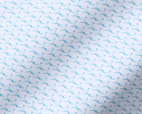 The Atwood Boys Shirt: Harbor features a white knit fabric with a teal flagstick motif, offering moisture-wicking, breathable comfort with UPF 50+ protection.