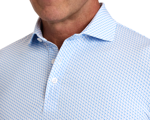 The Atwood Shirt: Horizon Blue, featuring a light blue with dark blue geometric pattern, open collar, structured spread collar, and part of a man's tanned jawline.