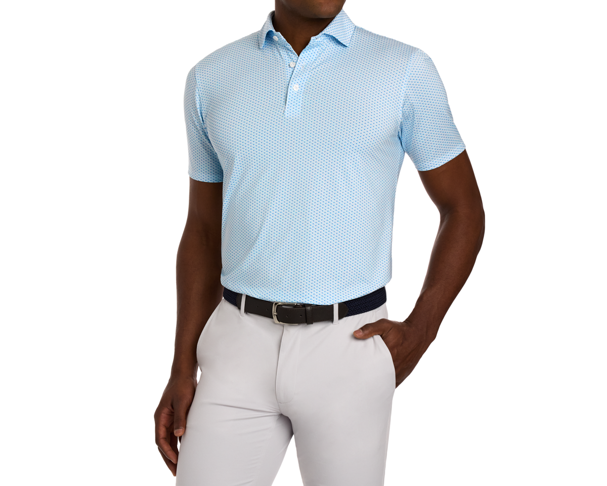 The Fulton Shirt: Harbor & Maidstone Blue, featuring a subtle cocktail pattern, tucked into trousers, showcasing comfort with a structured collar and performance fabric.