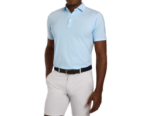The Fulton Shirt: Harbor & Maidstone Blue, a light-blue polo with cocktail pattern, worn tucked into stone shorts, featuring a woven dark belt.