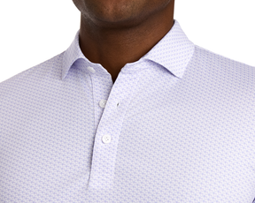 The Fulton Shirt: Vista Blue & Tudor features a white polo with a light purple geometric cocktail motif, button-placket, spread collar, ideal for warm-weather comfort.