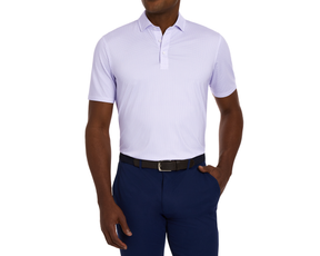 Man wearing The Fulton Shirt: Vista Blue & Tudor, a light lavender-tone polo with a subtle cocktail pattern, paired with navy trousers and a black belt.