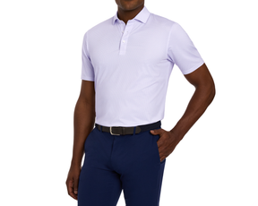 Man wearing The Fulton Shirt: Vista Blue & Tudor, a light lavender polo with a cocktail pattern, navy pants, and a woven navy belt.