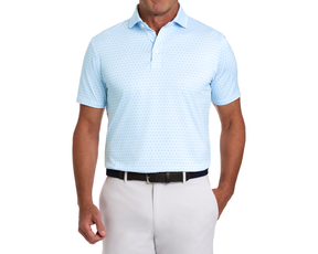 Male model wearing The Rivers Shirt: Vista Blue & Horizon Blue, featuring a subtle horseshoe pattern, tucked into light-gray chinos with a dark braided belt.