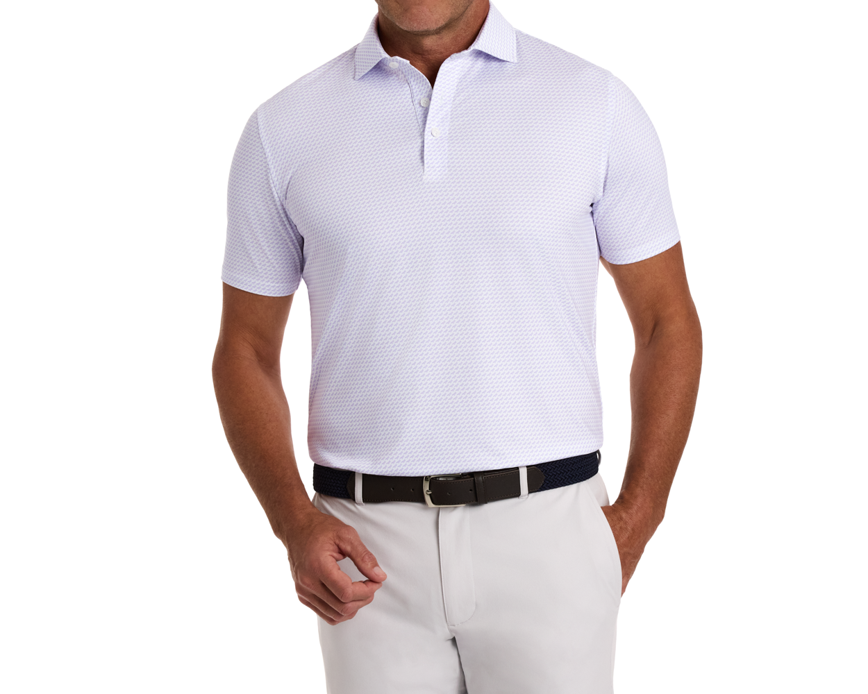 Man wearing The Walton Shirt: Tudor, a light-lavender polo with subtle patterns, tucked into light trousers, featuring a navy belt.