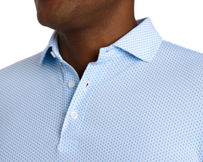 The Lennox Shirt: Vista Blue & Horizon Blue features a chevron-style pattern, classic collar, and white buttons, offering breathable comfort and UPF 30+ protection.