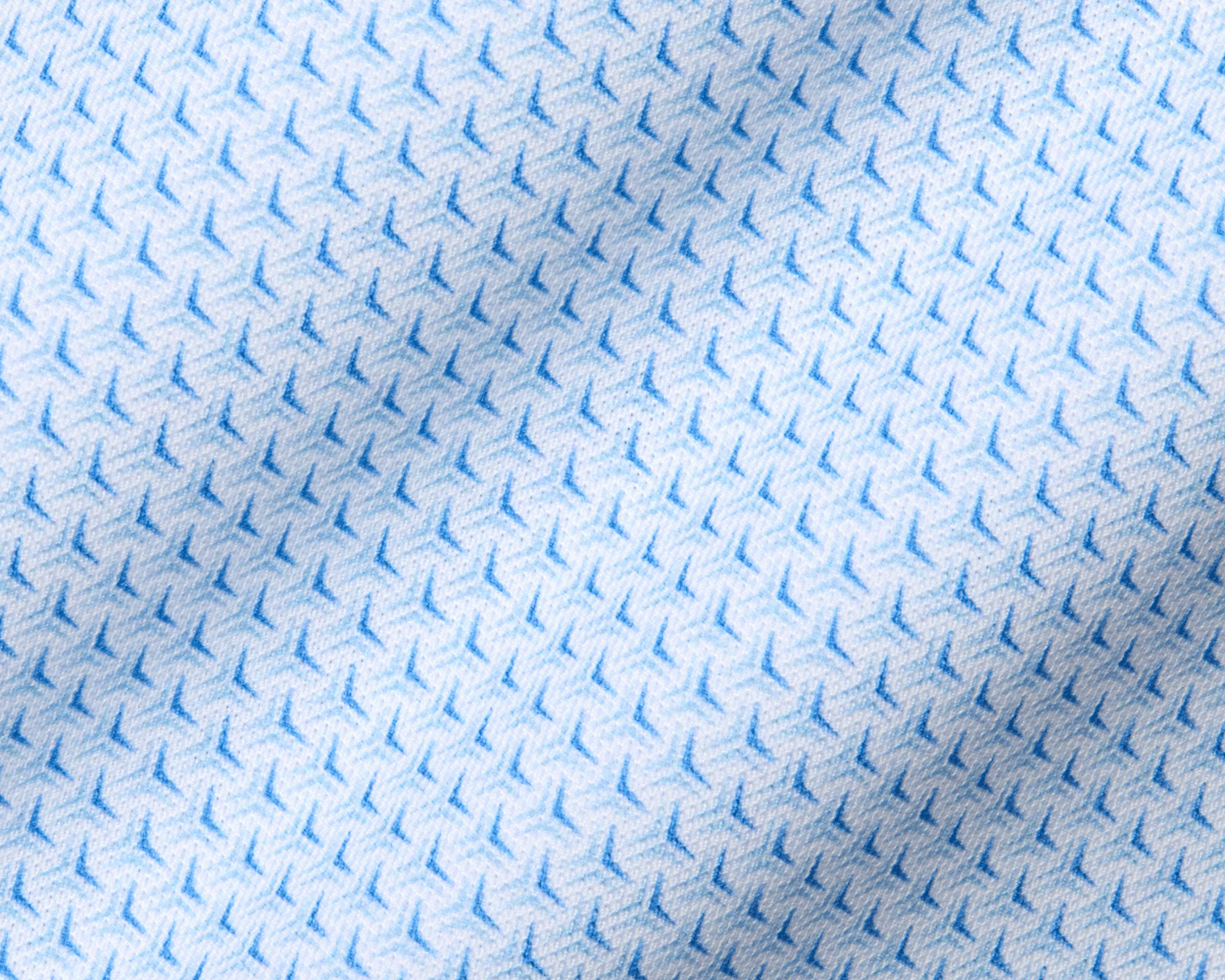 Close-up of The Lennox Shirt: Vista Blue & Horizon Blue, showcasing its textured fabric with a repeating blue arrow motif and refined star pattern for sophisticated style.