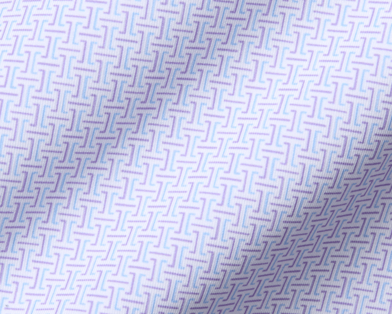The Norwood Shirt: Vista Blue & Tudor features a woven geometric pattern with T-shaped motifs, showcasing subtle folds and a structured spread collar.