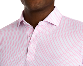 The Geiger Shirt: Belmont features a light button-up polo with a pink geometric pattern, breathable pique fabric, and structured collar for comfort and sun protection.