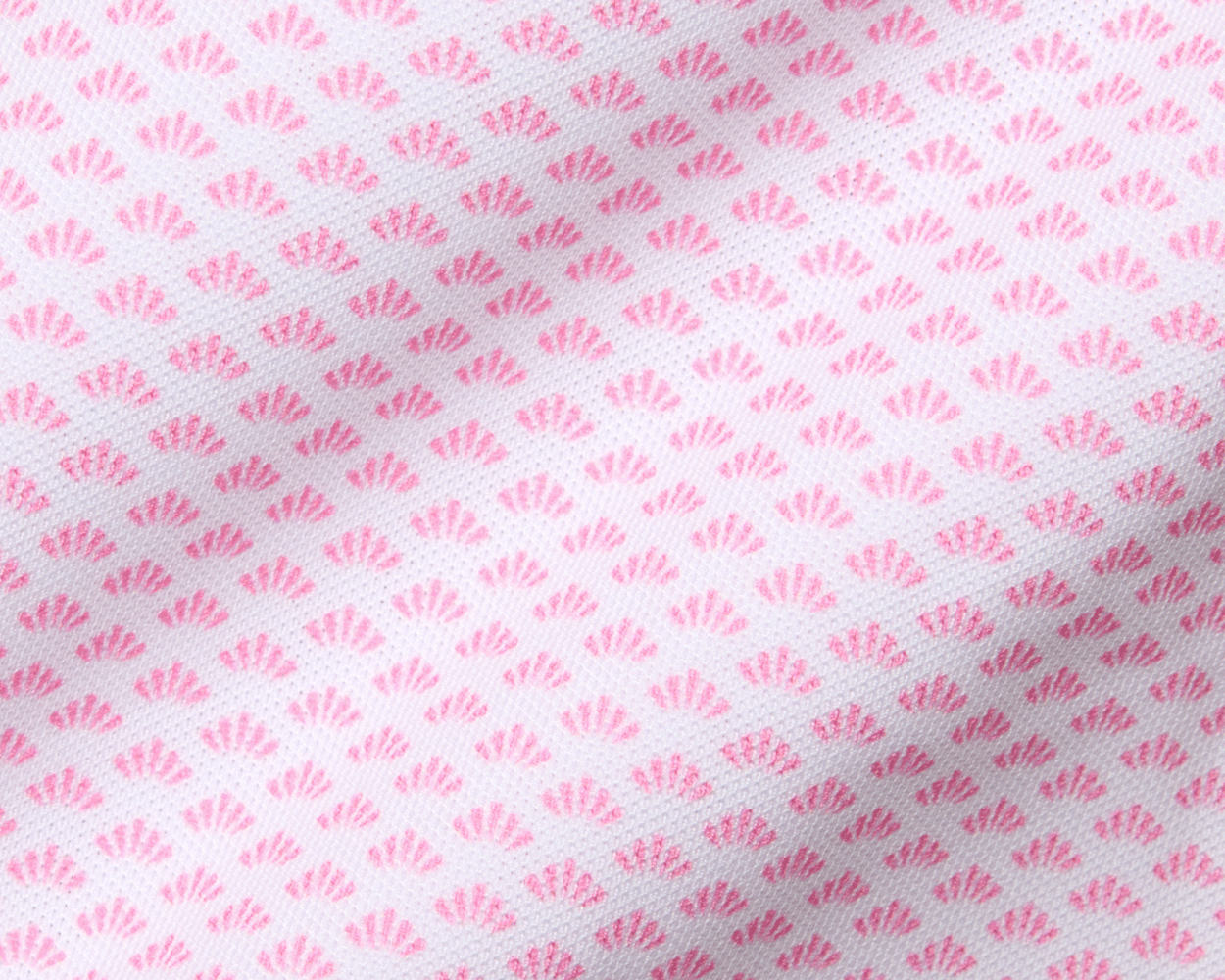The Geiger Shirt: Belmont features a light fabric with pink fan-shaped motifs, offering breathability, moisture-wicking, and UPF 30+ protection with a structured collar.
