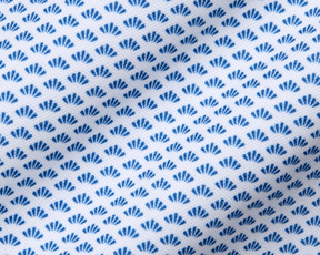 The Geiger Shirt: Maidstone Blue features a close-up of its white fabric with a grid of small blue fan motifs, highlighting its breathable, moisture-wicking pique texture.