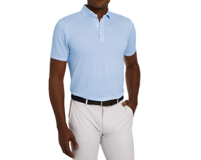Model wearing The Geiger Shirt: Maidstone Blue, showcasing its geometric pattern, breathability, and structured collar, paired with light gray trousers and a black belt.