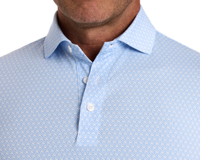 The Griffin Shirt: Horizon Blue features a light-blue polo with a subtle griffin pattern, classic collar, and three-button placket.
