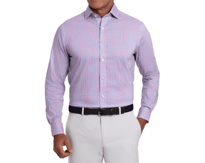 Man wearing The Wright Shirt: Belmont, a long-sleeve, button-down with small check pattern, tucked into gray trousers. Features structured spread collar and performance fabric.