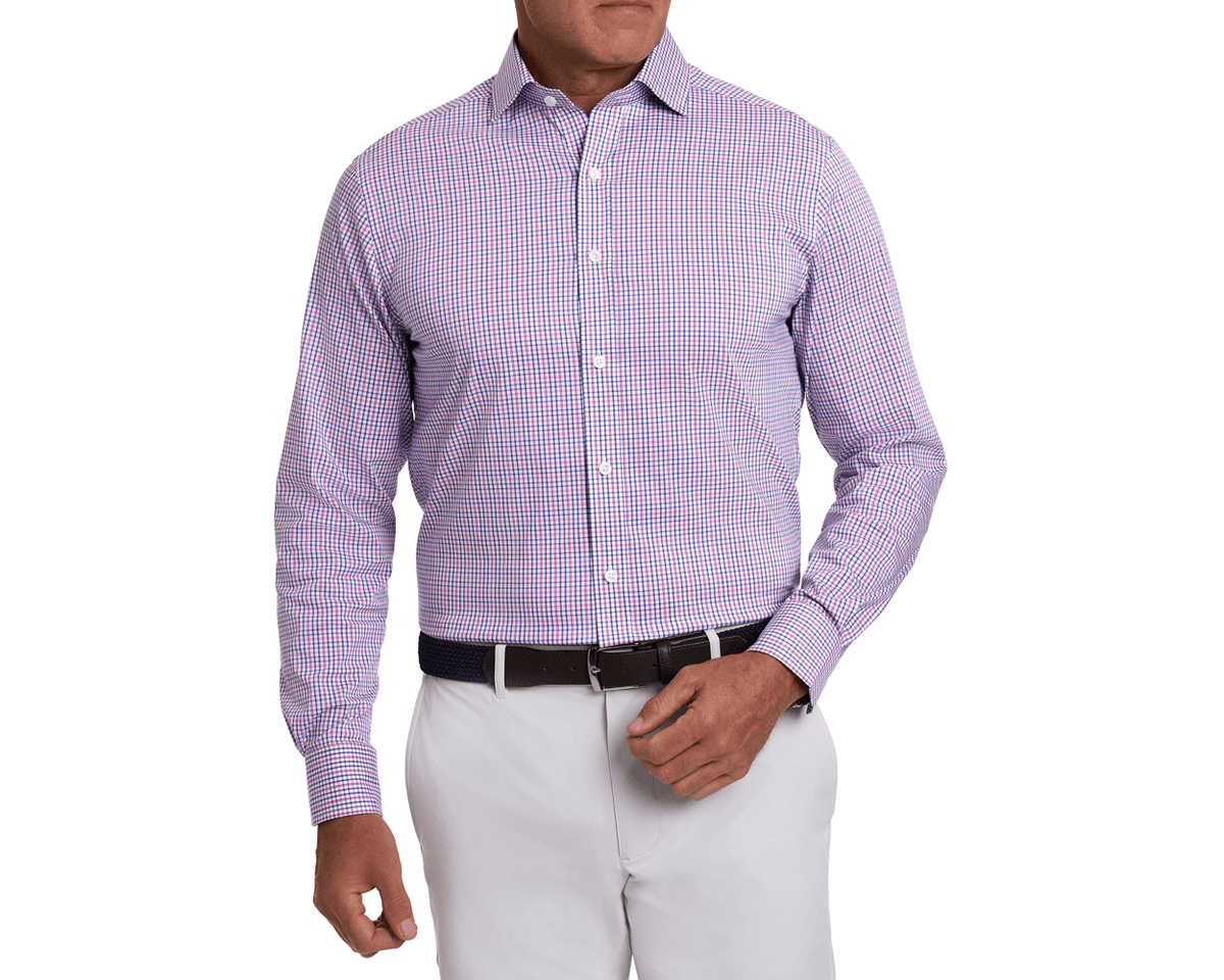 Man wearing The Wright Shirt: Belmont, a blue-and-pink check dress shirt with button-front design, tucked into trousers, featuring breathable, stretch poplin fabric.
