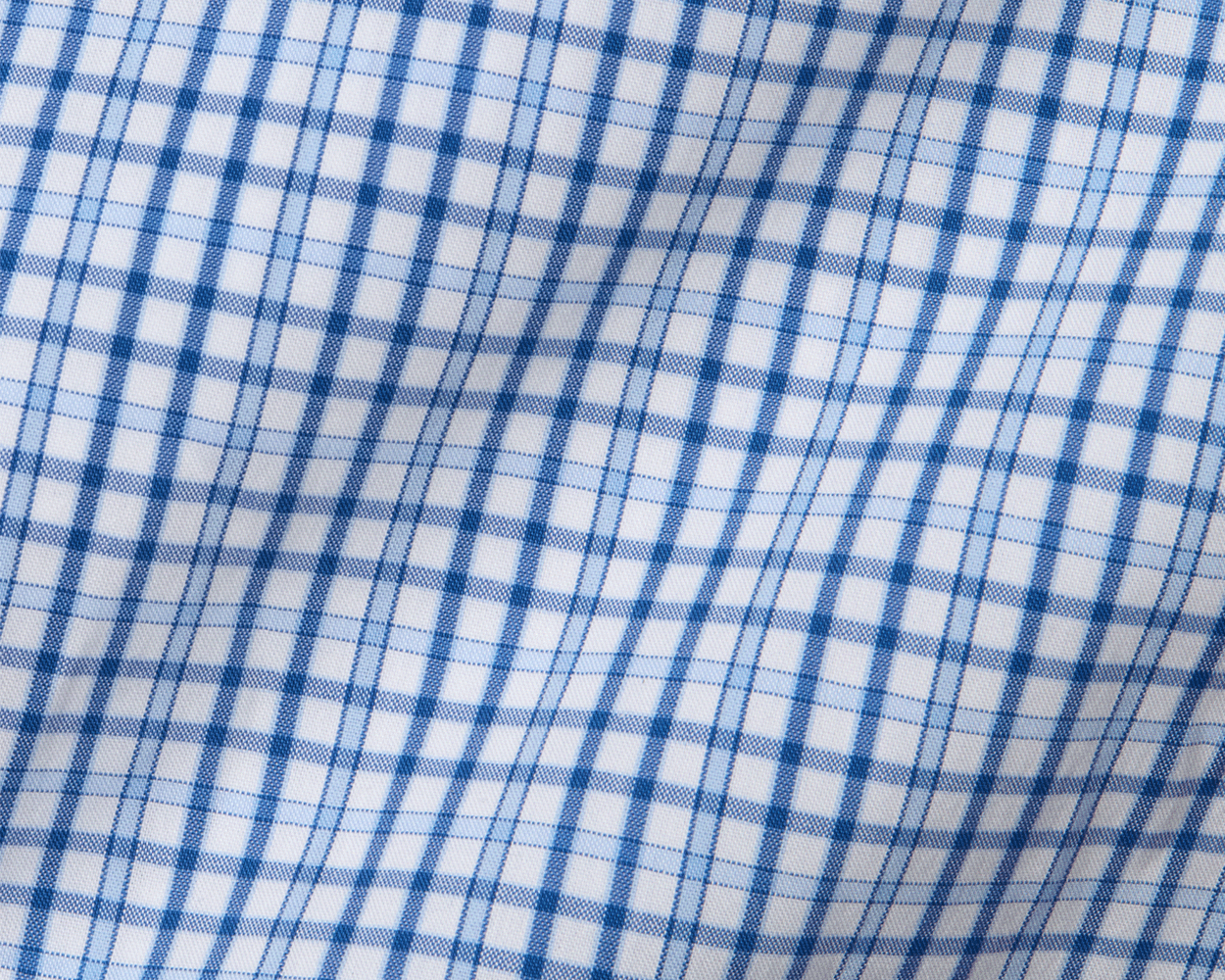 The Wright Shirt: Vista Blue, featuring a blue-and-white plaid pattern, showcases a crisp cotton-blend poplin with moisture-wicking and wrinkle-resistant properties.