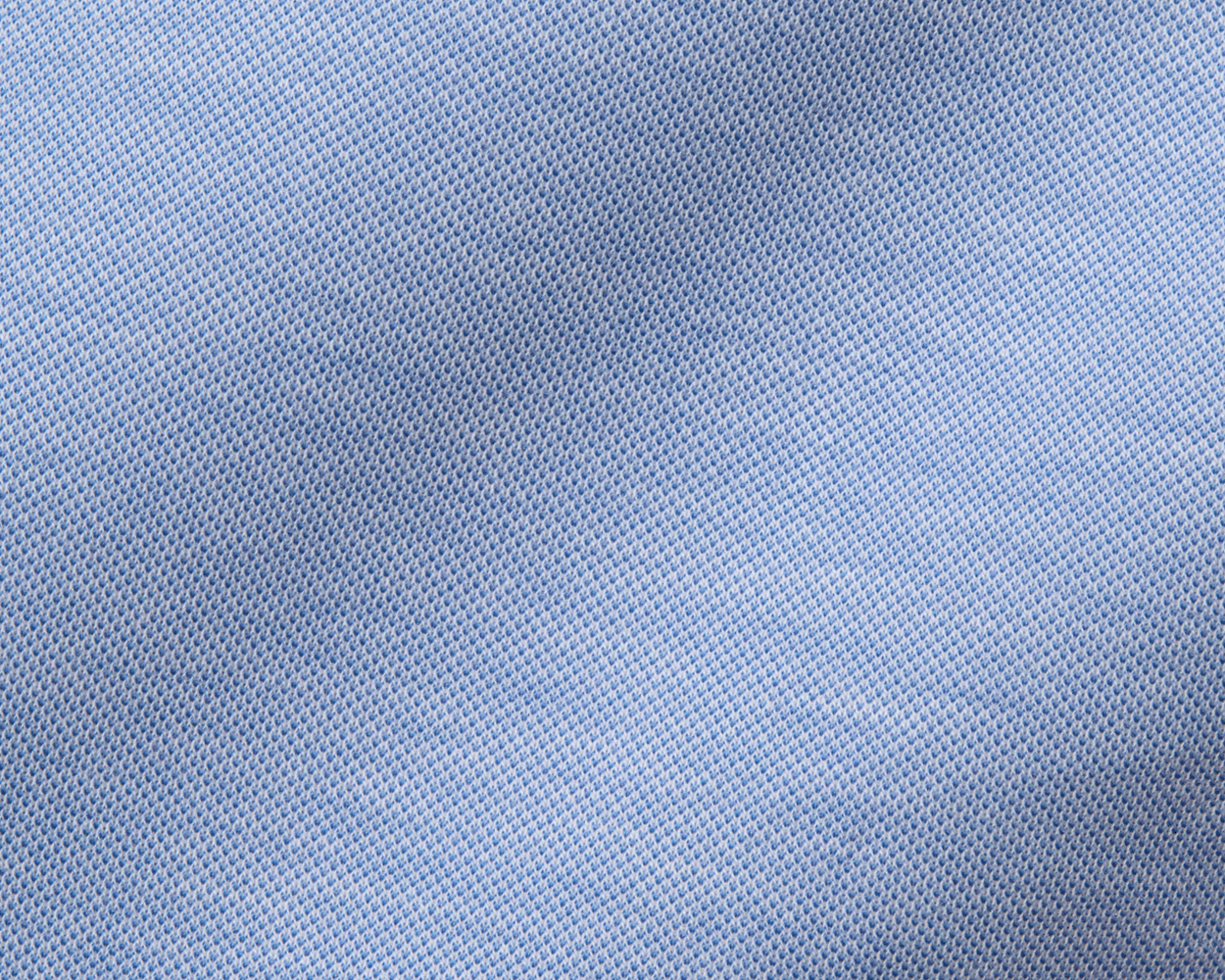 The Cullinane Shirt: Heathered Maidstone Blue features a close-up of its light-blue piqué texture, showcasing breathable knit and stylish, polished comfort.