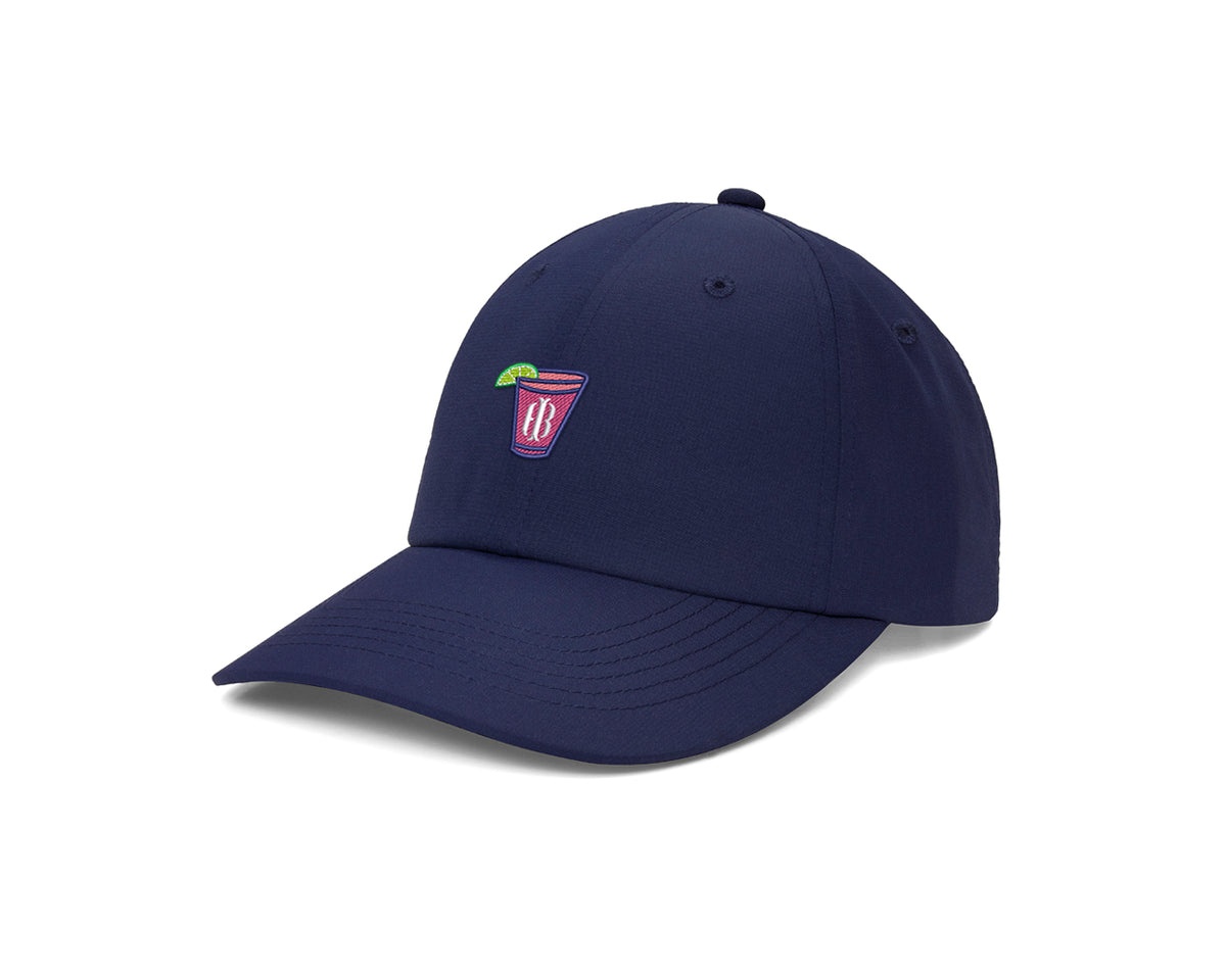 The Lightweight Performance Hat: Navy with Transfusion Icon features a navy-blue cap with a pink drink patch, curved brim, and adjustable closure.