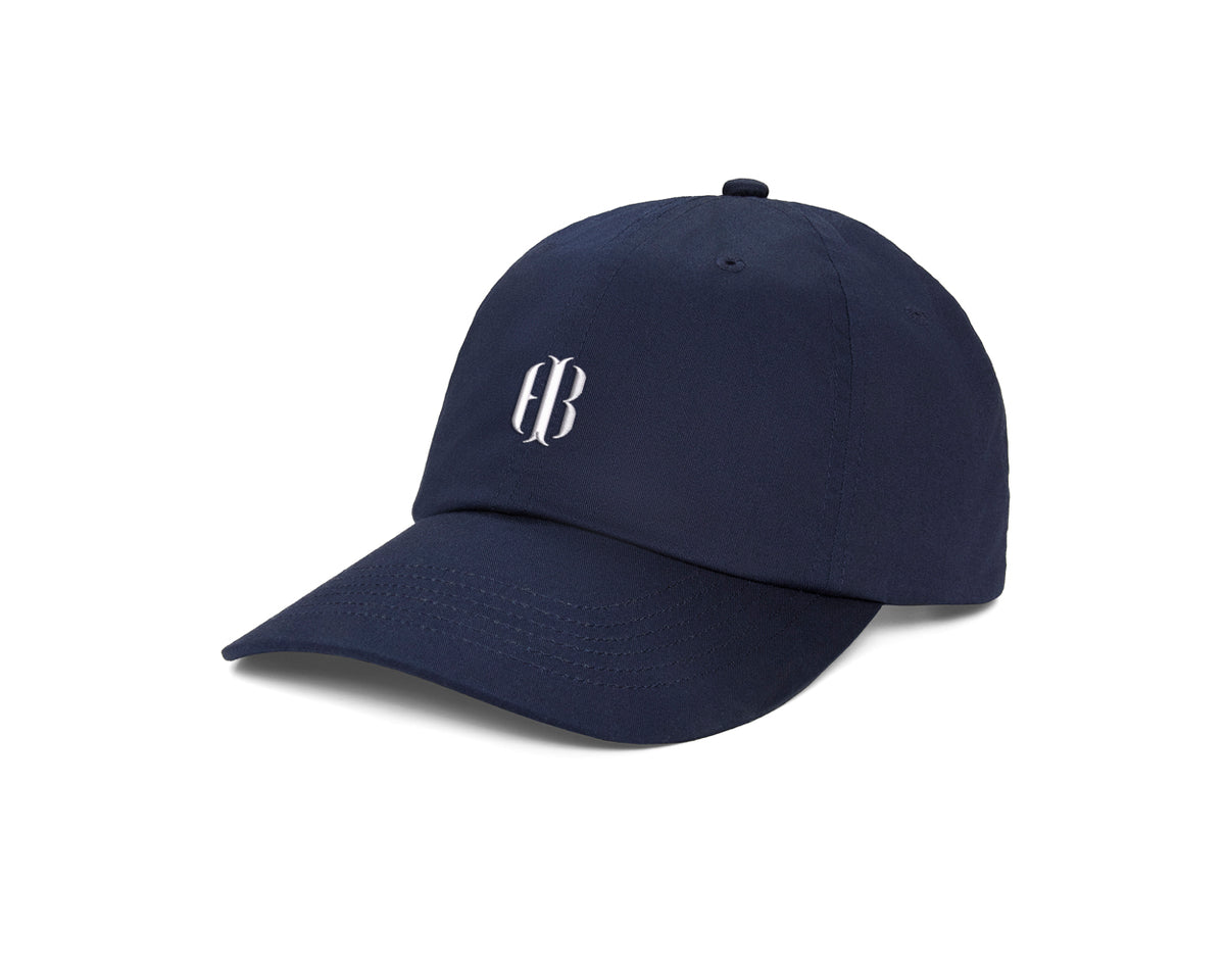 The Lightweight Cotton Hat: Navy with HB Icon, features a six-panel design, curved brim, white embroidered logo, and adjustable closure for comfort.