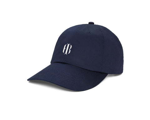 The Lightweight Cotton Hat: Navy with HB Icon, features a six-panel design, curved brim, white embroidered logo, and adjustable closure for comfort.