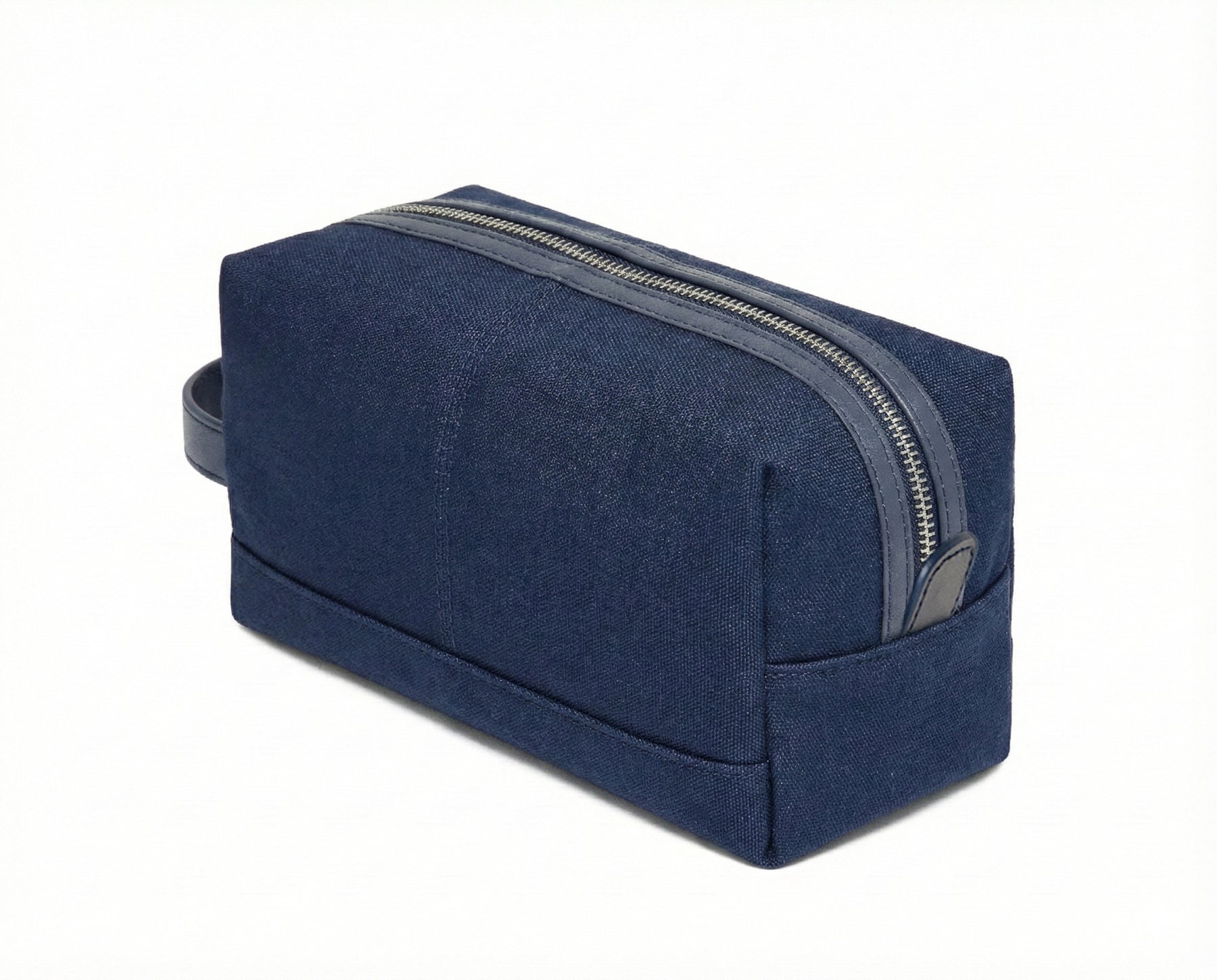 The Littler Dopp Kit: Navy Ballistic, a rectangular canvas travel bag with a top zipper, small side handle, and water-resistant interior pocket.